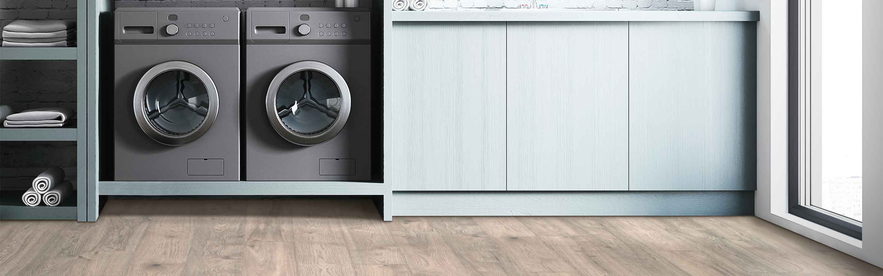 Laminate flooring in a laundry room with washer and dryer
